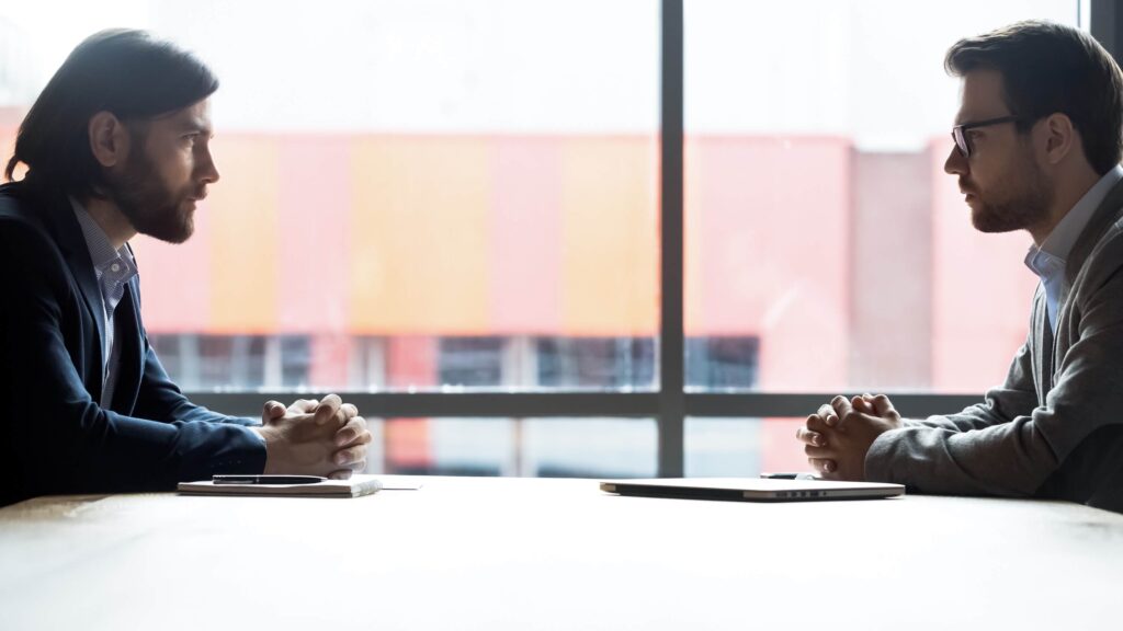 businesspeople sitting at office table discussing in boardroom